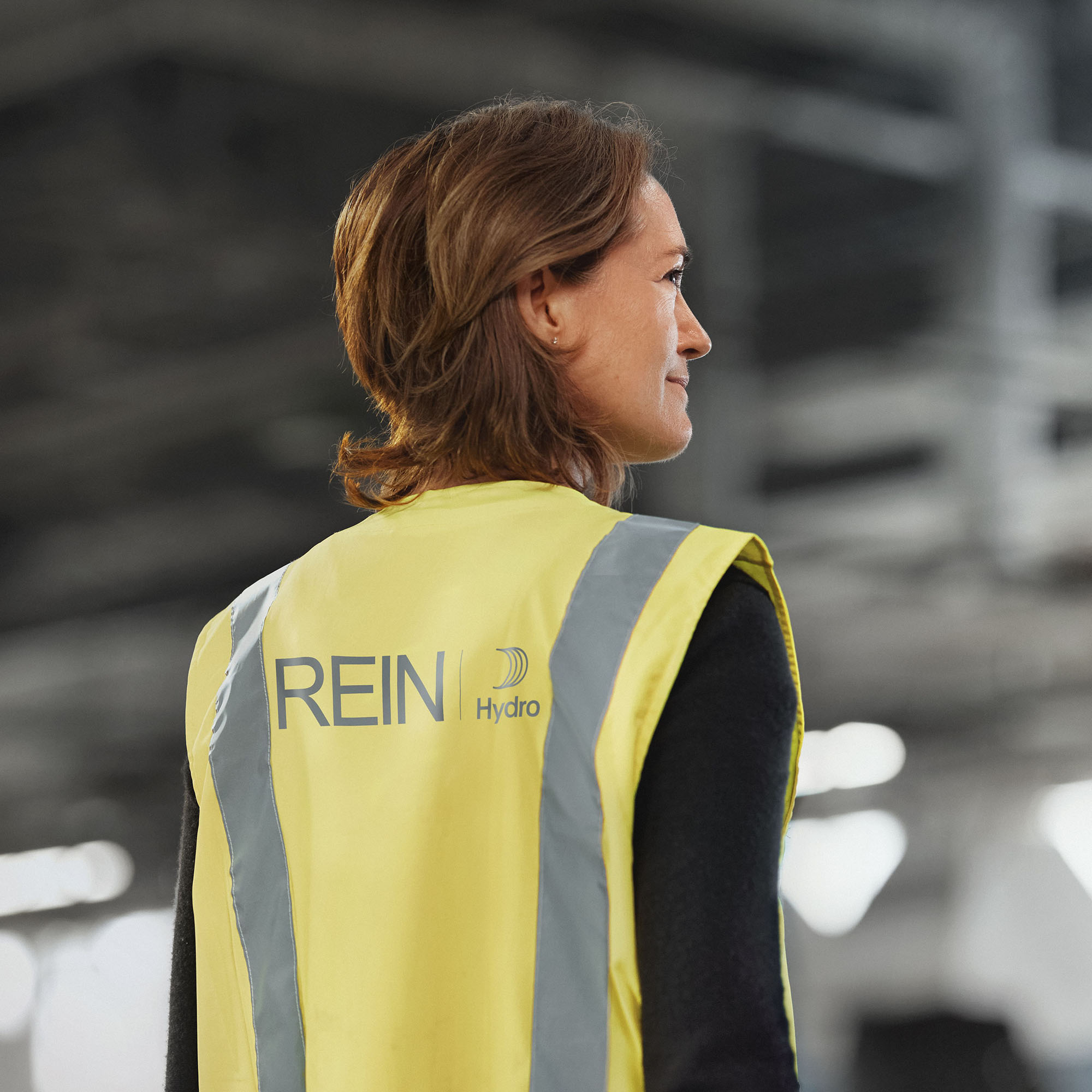 a woman wearing a yellow vest