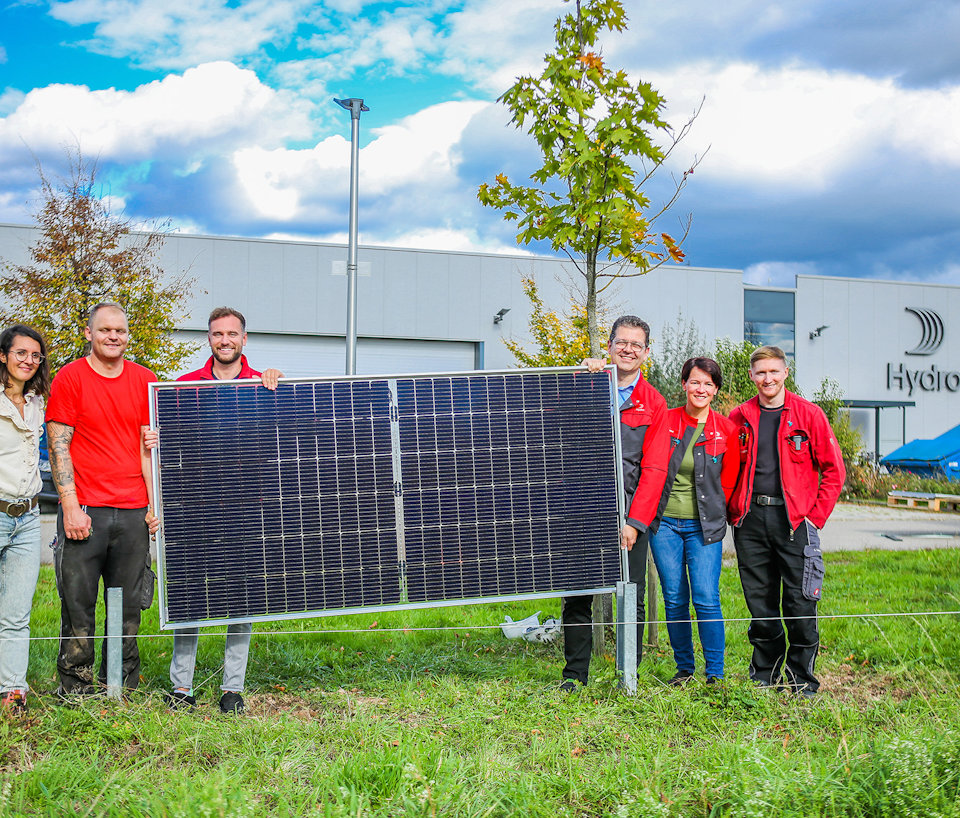 a group of people standing in front of a sign