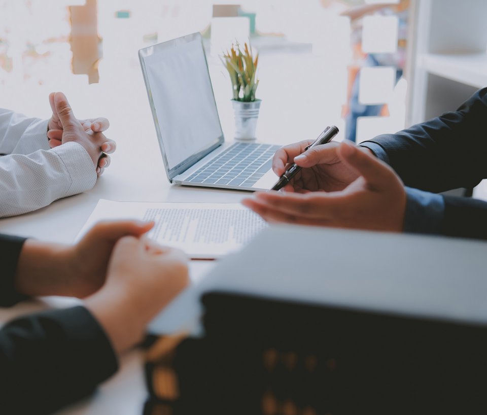 a few people working on a laptop